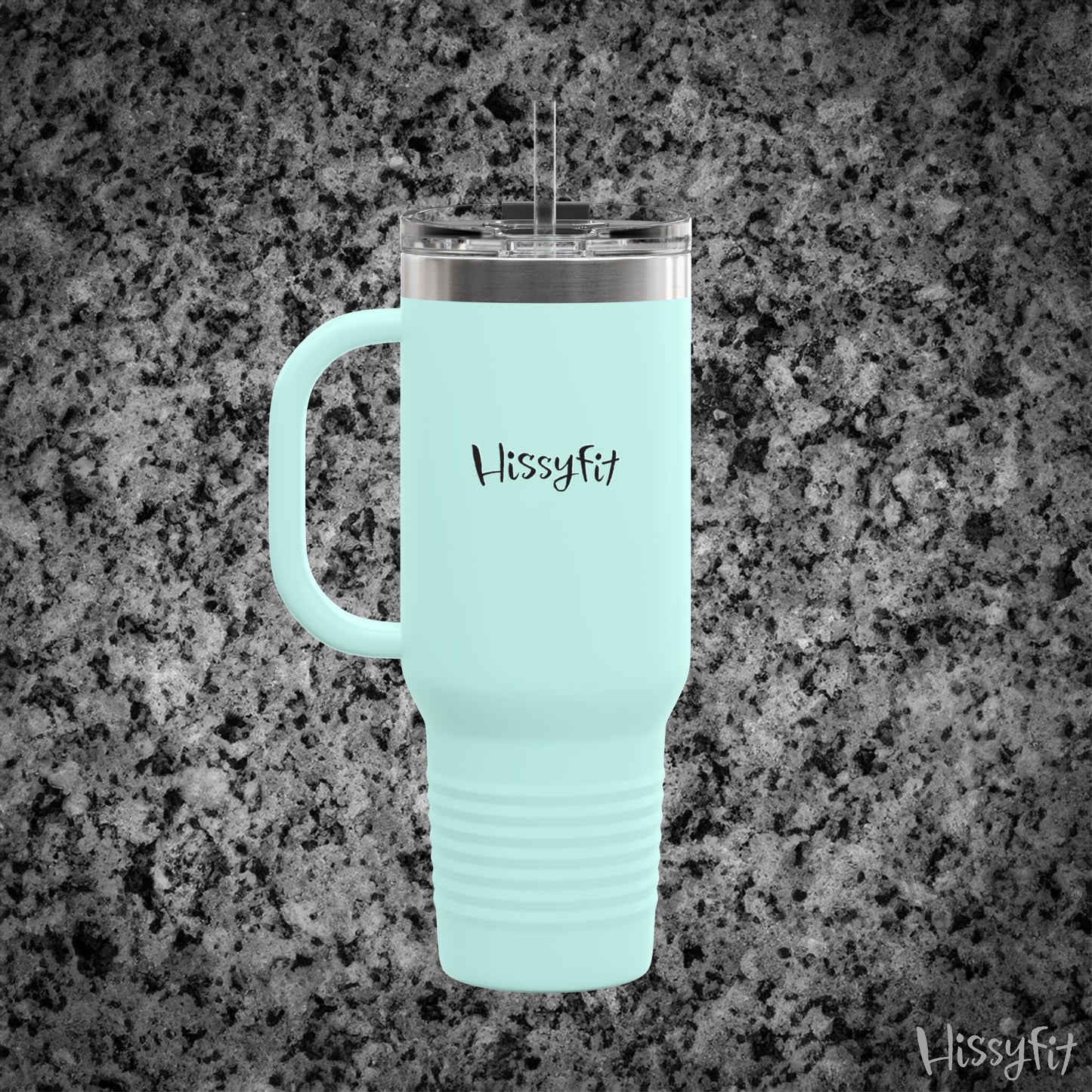 Light blue travel mug with handle on a gray granite background, featuring the brand 'Hissyfit'.