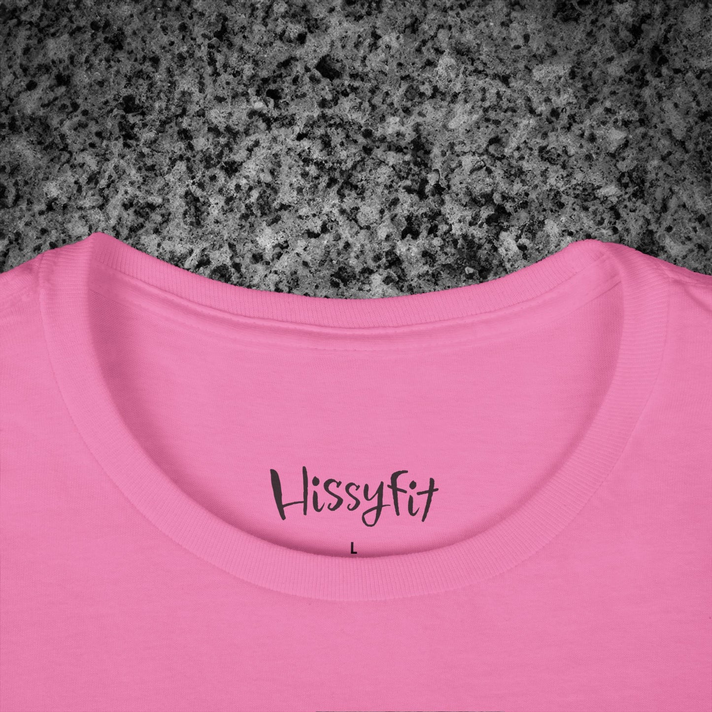 Pink t-shirt with 'Hissyfit' text on a gray granite surface