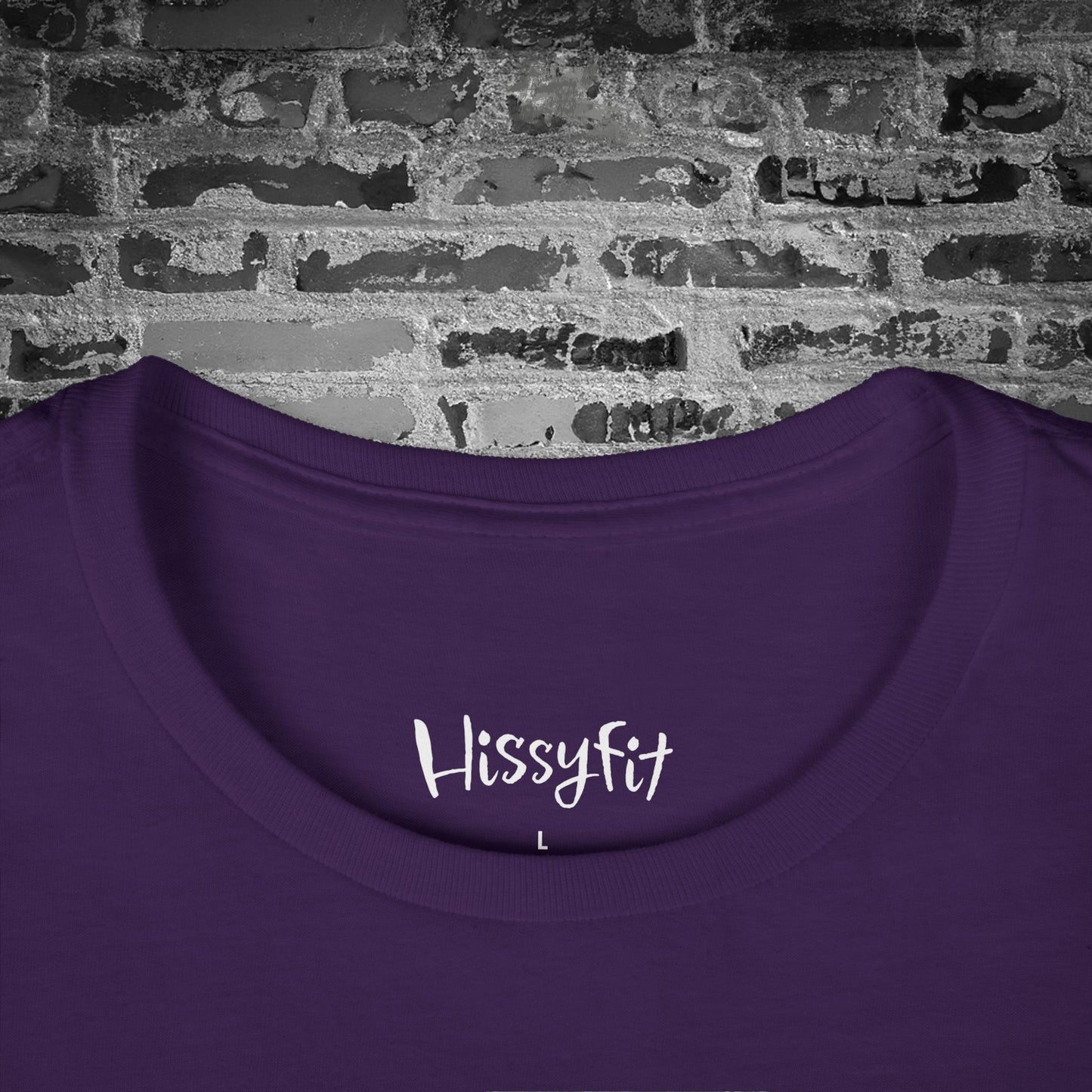 Purple shirt with 'Hissyfit' text on a brick wall background