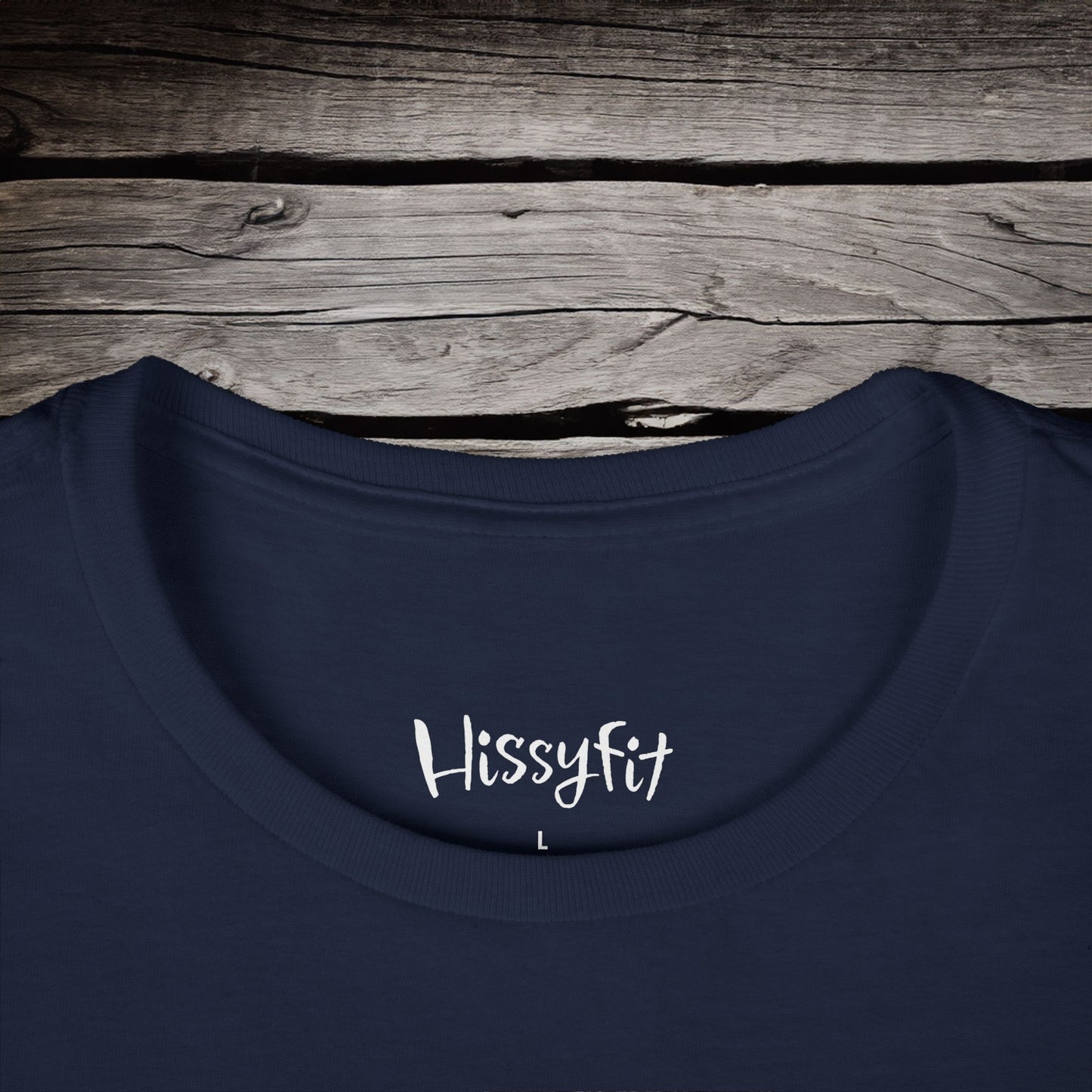Navy blue shirt with 'Hissyfit' text on a wooden surface