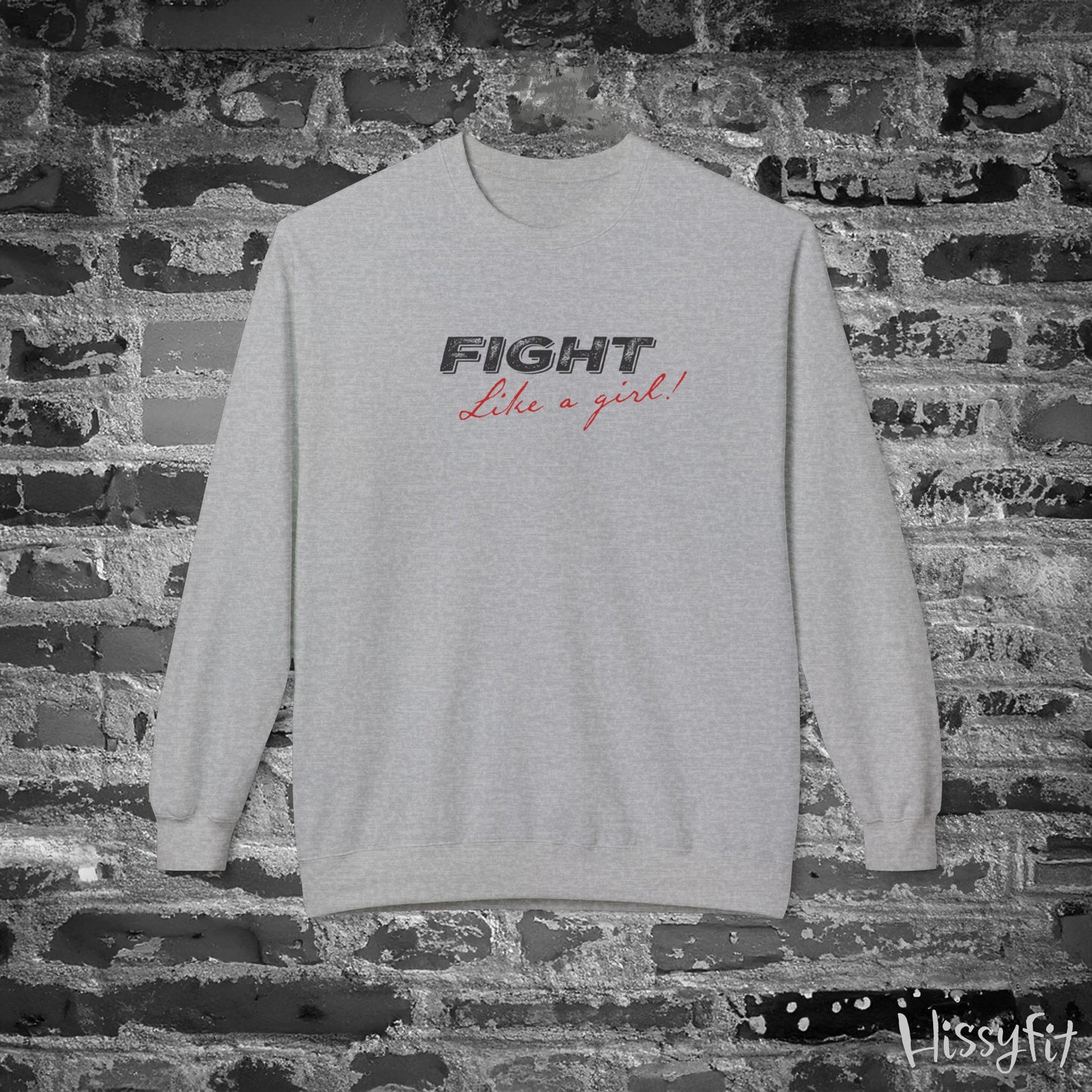 Light Gray sweatshirt with 'Fight Like a Girl' text on a brick wall, featuring the brand 'Hissyfit'.