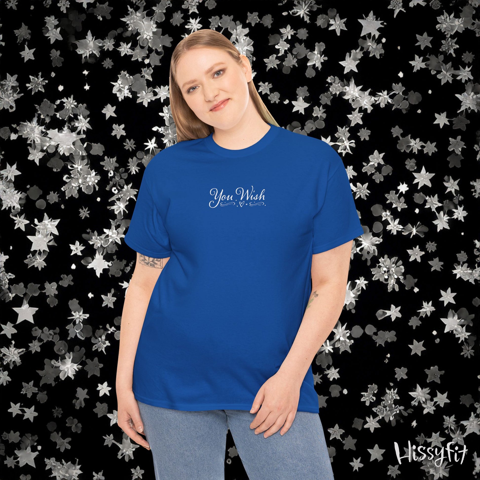 Person wearing a blue t-shirt with text against a star-patterned background