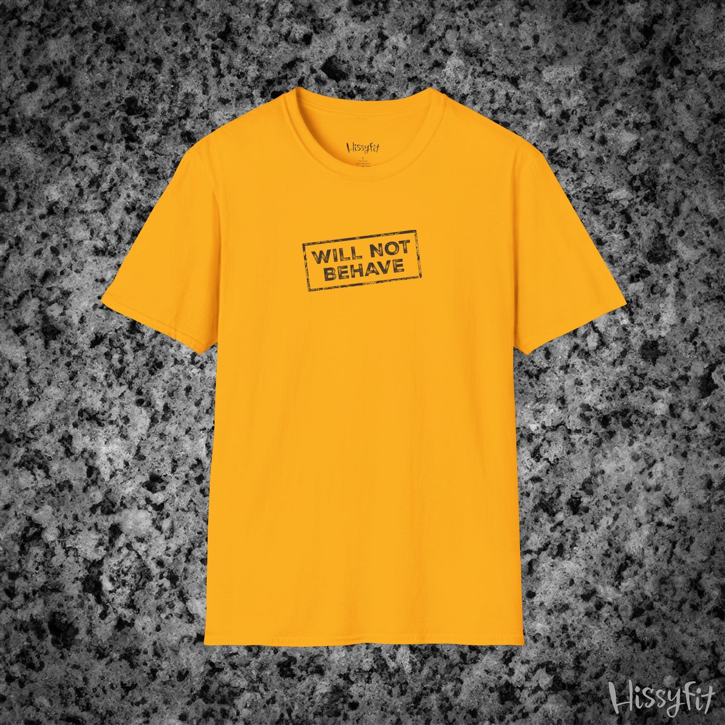 Yellow t-shirt with 'WILL NOT BEHAVE' text on a textured gray background
