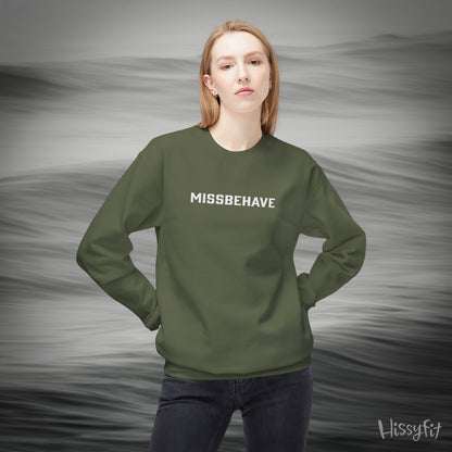 Person wearing a green sweatshirt with 'MISSBEHAVE' text against a gray background