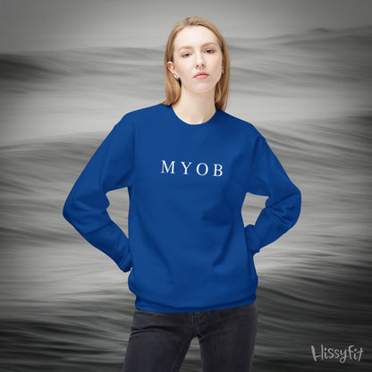 Person wearing a blue sweatshirt with 'MYOB' text against a gray background
