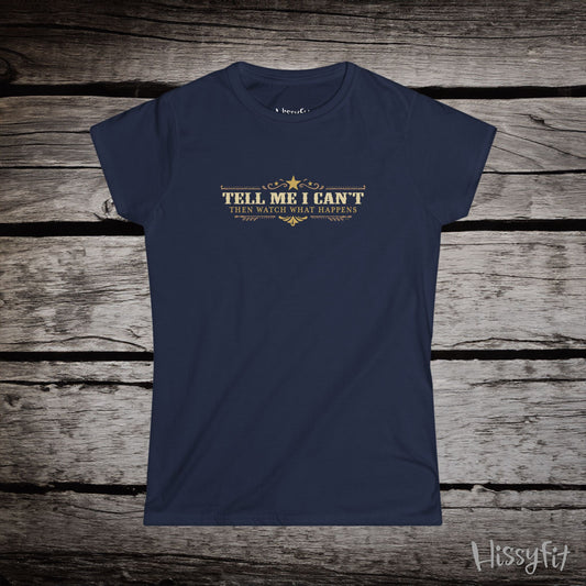 Navy blue t-shirt with text 'Tell me I can't then watch what happens' on a wooden surface, featuring the brand 'Hissyfit'.