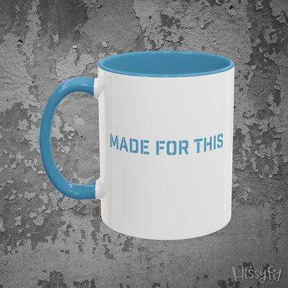 White mug with blue interior and handle on a textured gray background, featuring 'MADE FOR THIS' text.