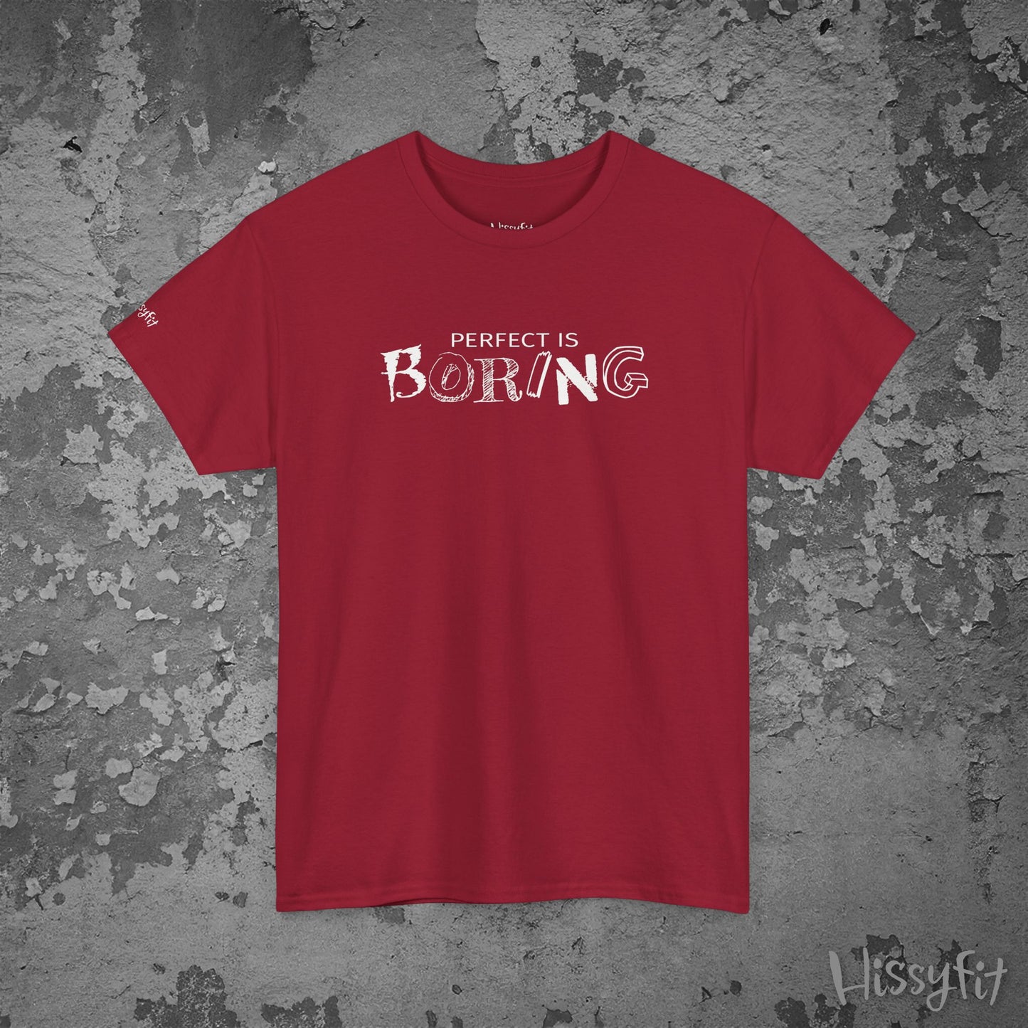 Red t-shirt with 'PERFECT IS BORING' text on a textured gray background