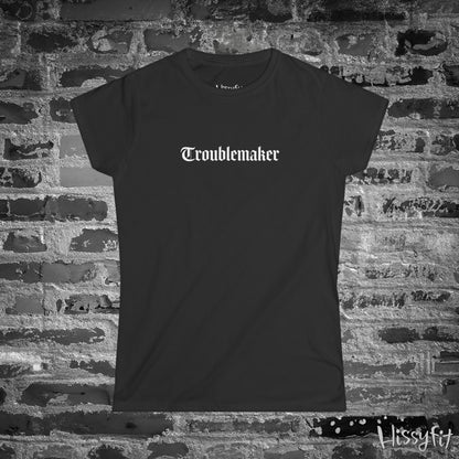 Black t-shirt with 'Troublemaker' text on a brick wall background