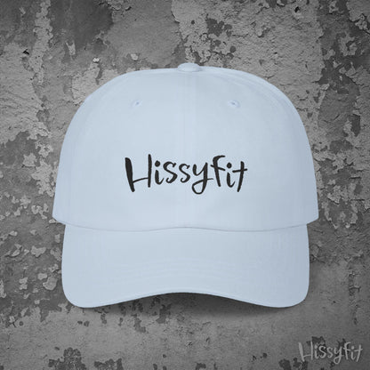 Light blue cap with 'Hissyfit' text on a textured gray background