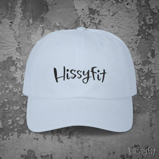Light blue cap with 'Hissyfit' text on a textured gray background