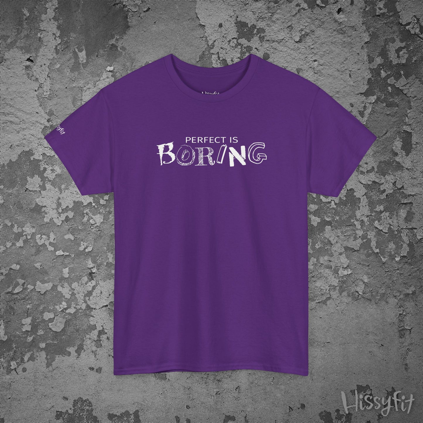 Purple t-shirt with 'PERFECT IS BORING' text on a textured gray background