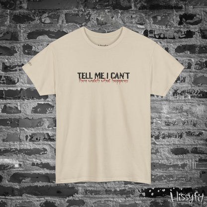 Beige t-shirt with text 'Tell me I can't then watch what happens' on a brick wall background