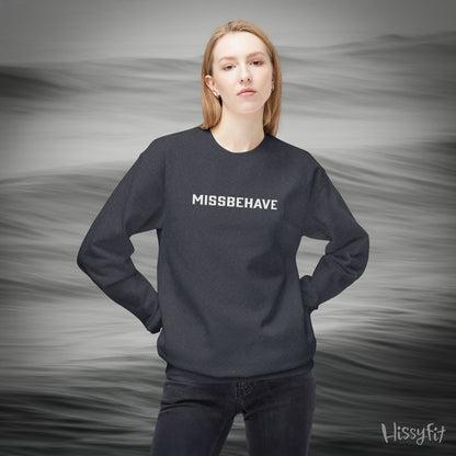 Person wearing a black sweatshirt with 'MISSBEHAVE' text against a gray background