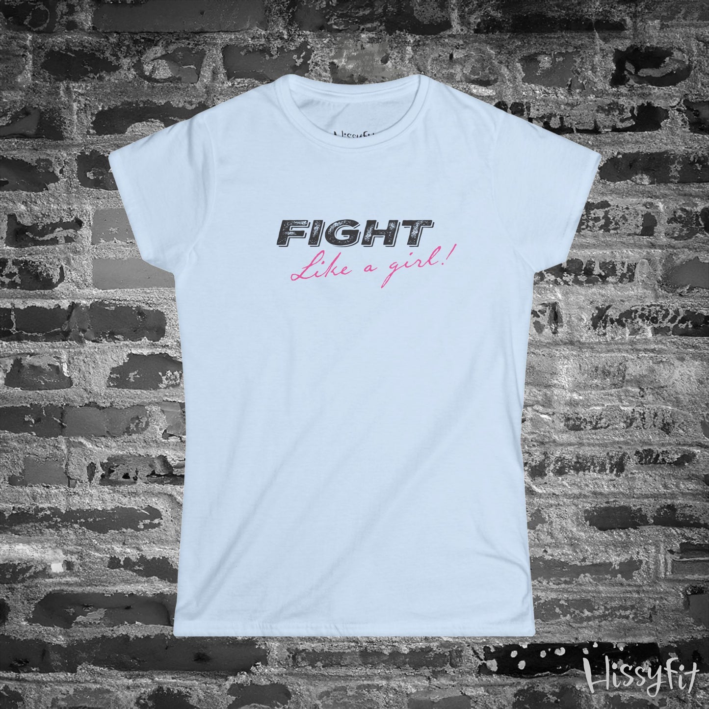 White t-shirt with 'Fight Like a Girl' text on a brick wall background