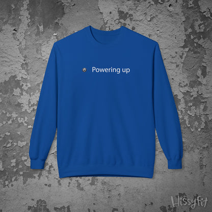 Blue sweatshirt with 'Powering up' text on a textured gray background