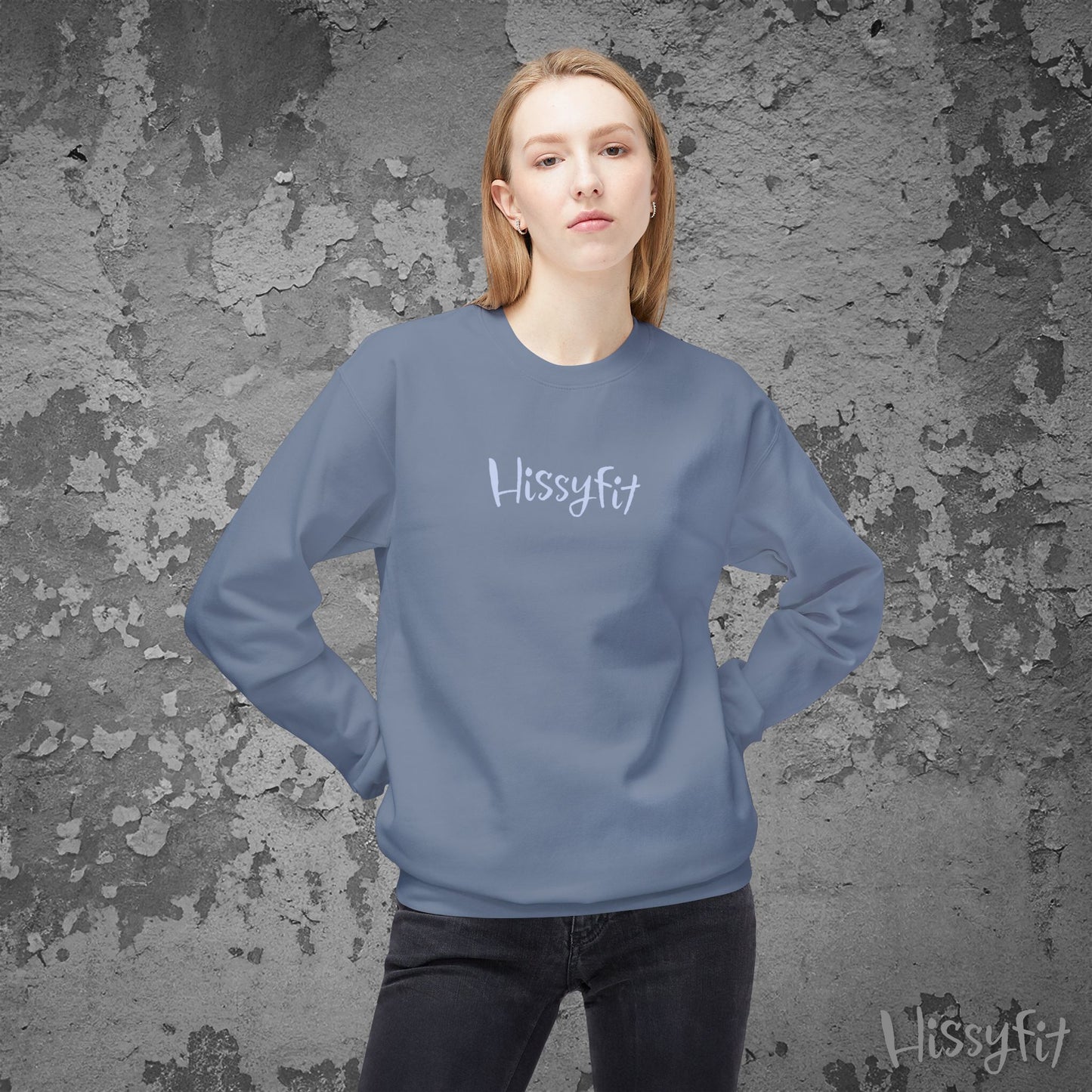 Person wearing a blue sweatshirt with 'Hissyfit' logo against a textured gray background