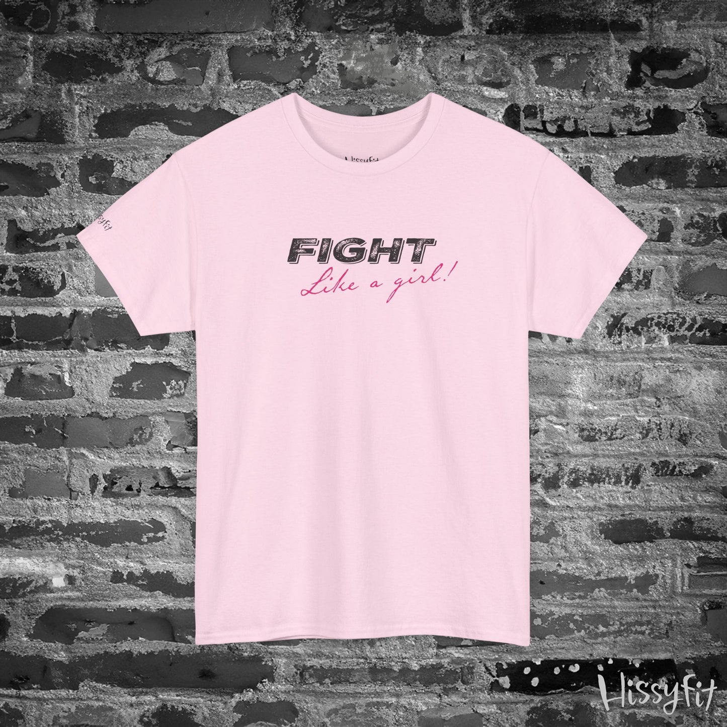 Light Pink t-shirt with 'Fight Like a Girl' text on a textured wall background