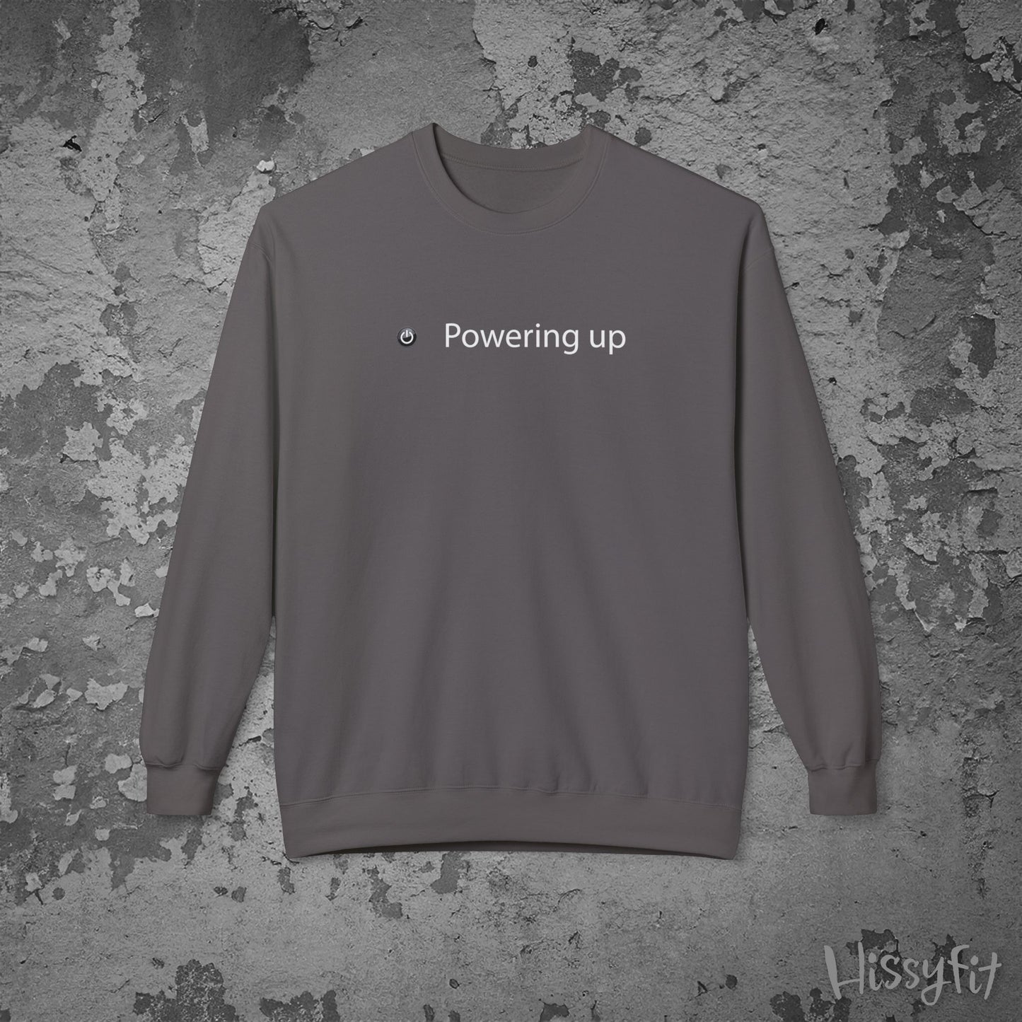 Gray sweatshirt with 'Powering up' text on a textured gray background