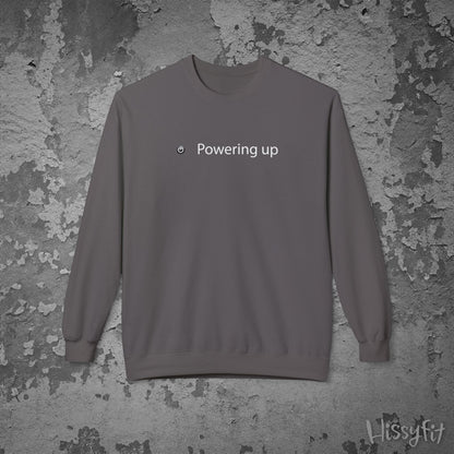Gray sweatshirt with 'Powering up' text on a textured gray background