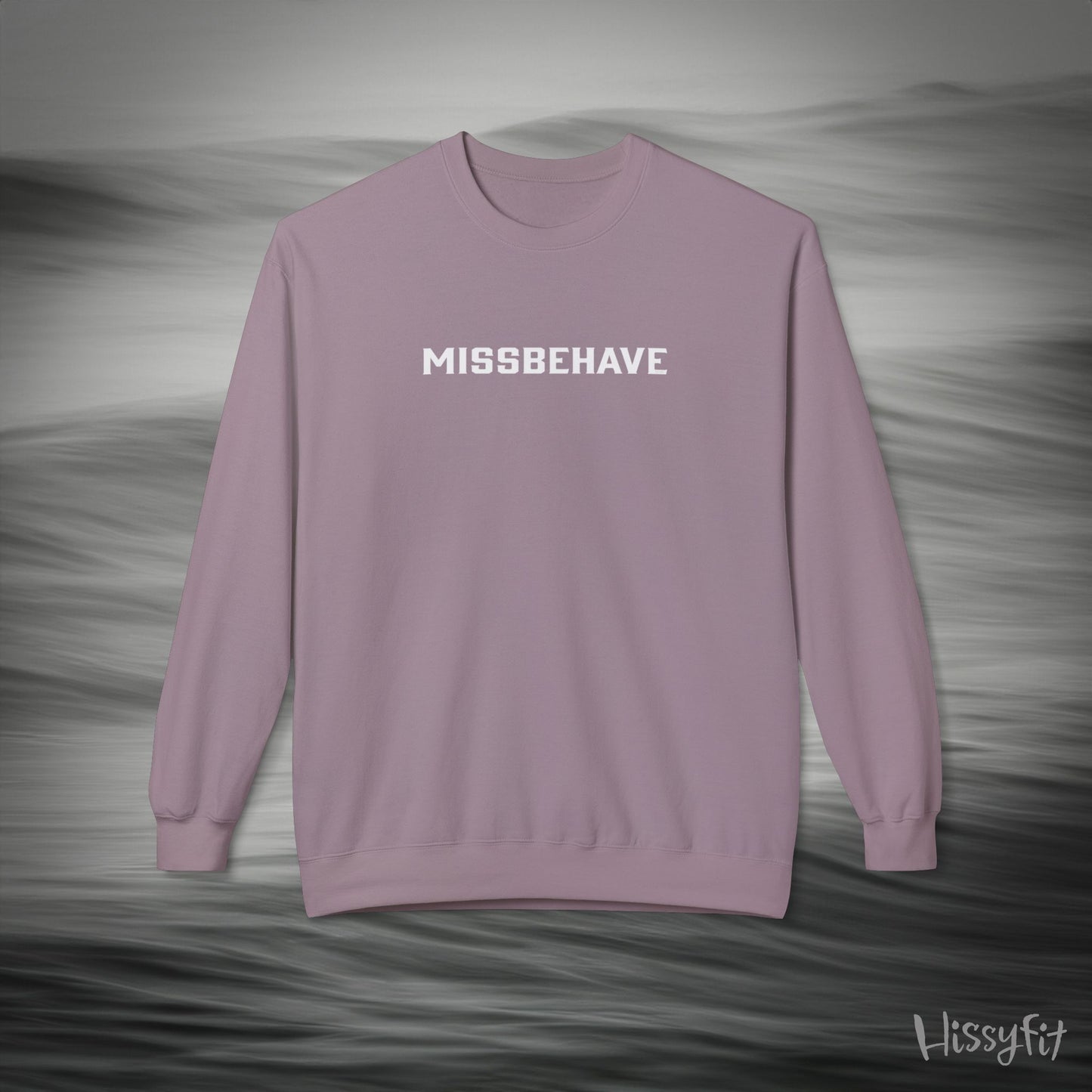 Purple sweatshirt with 'MISSBEHAVE' text on a gray background