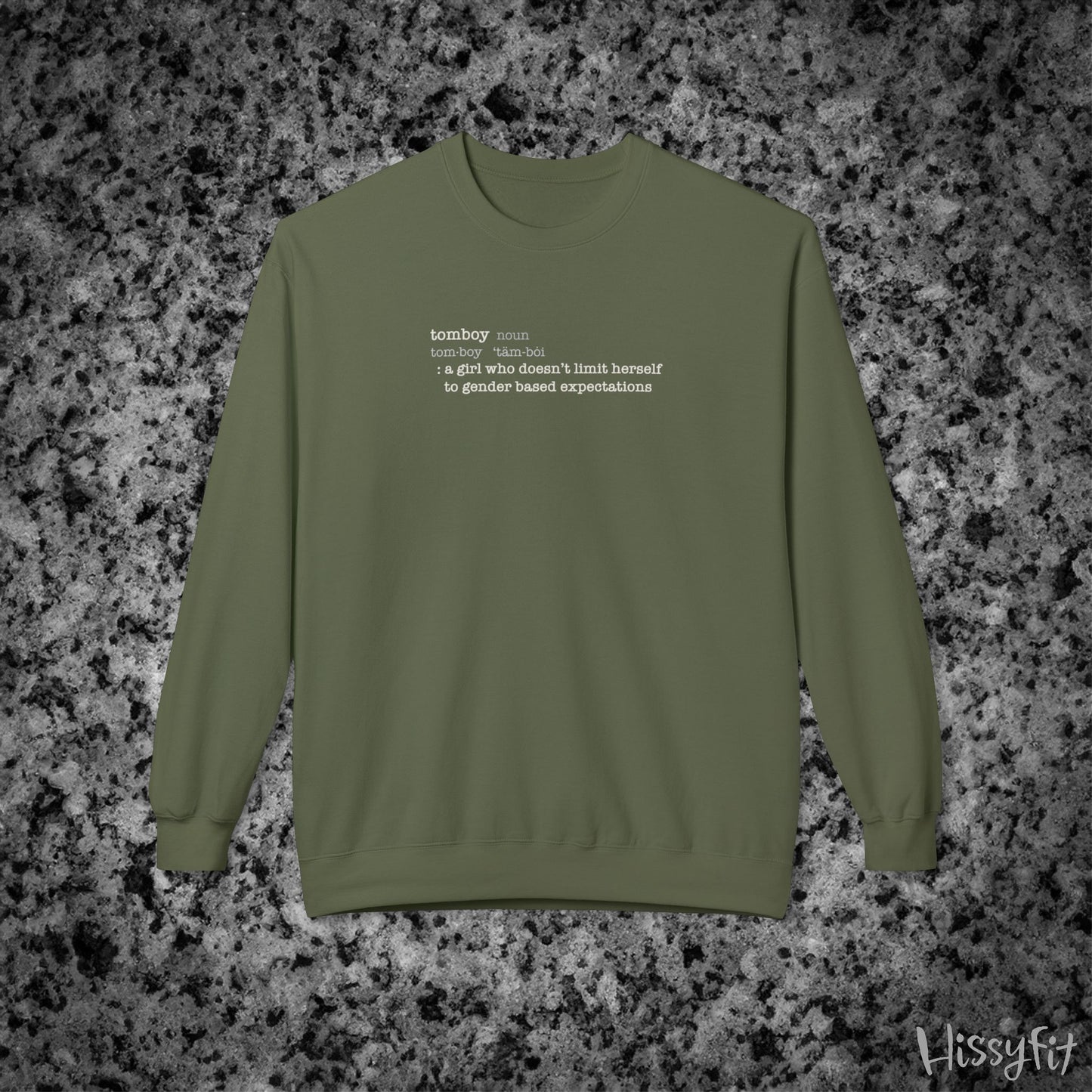 Green sweatshirt with text definition of "Tomboy" on a gray and black speckled background