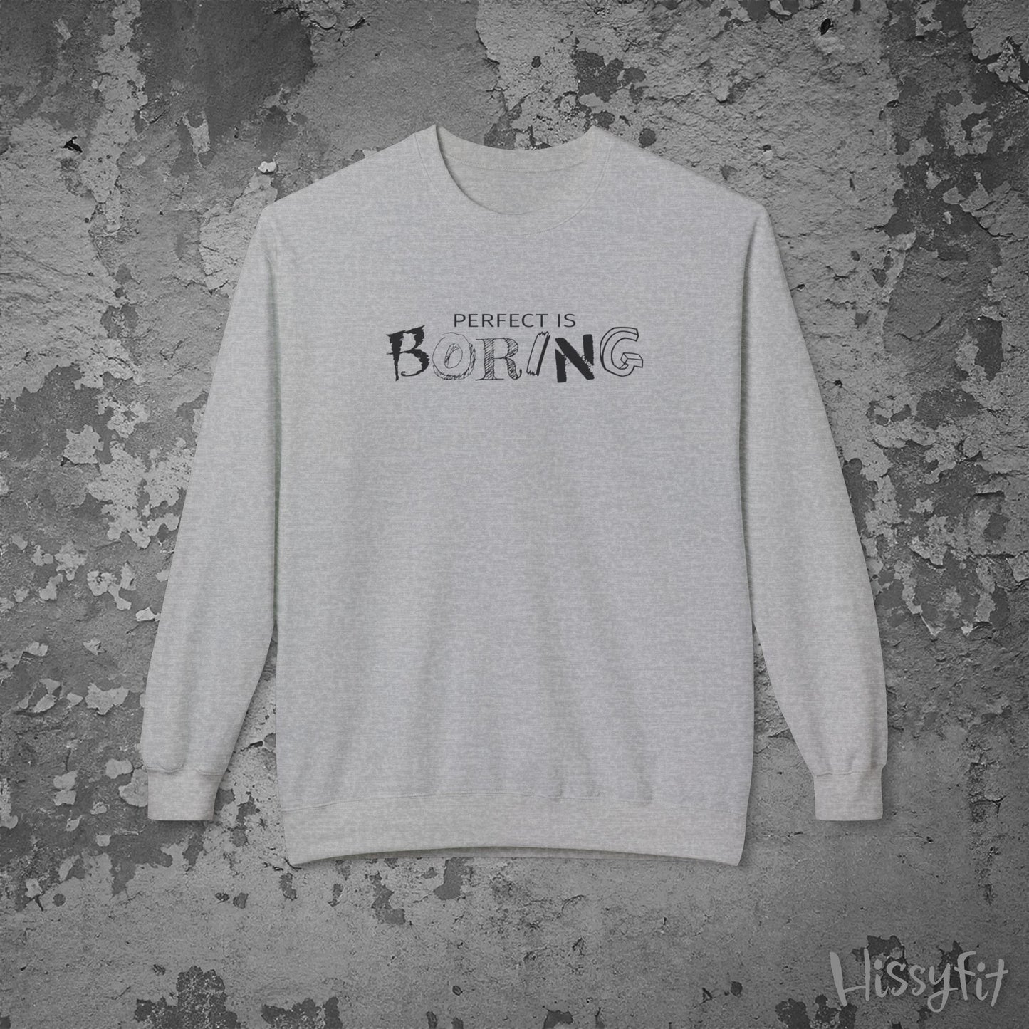 Gray sweatshirt with 'Perfect is Boring' text on a textured gray background