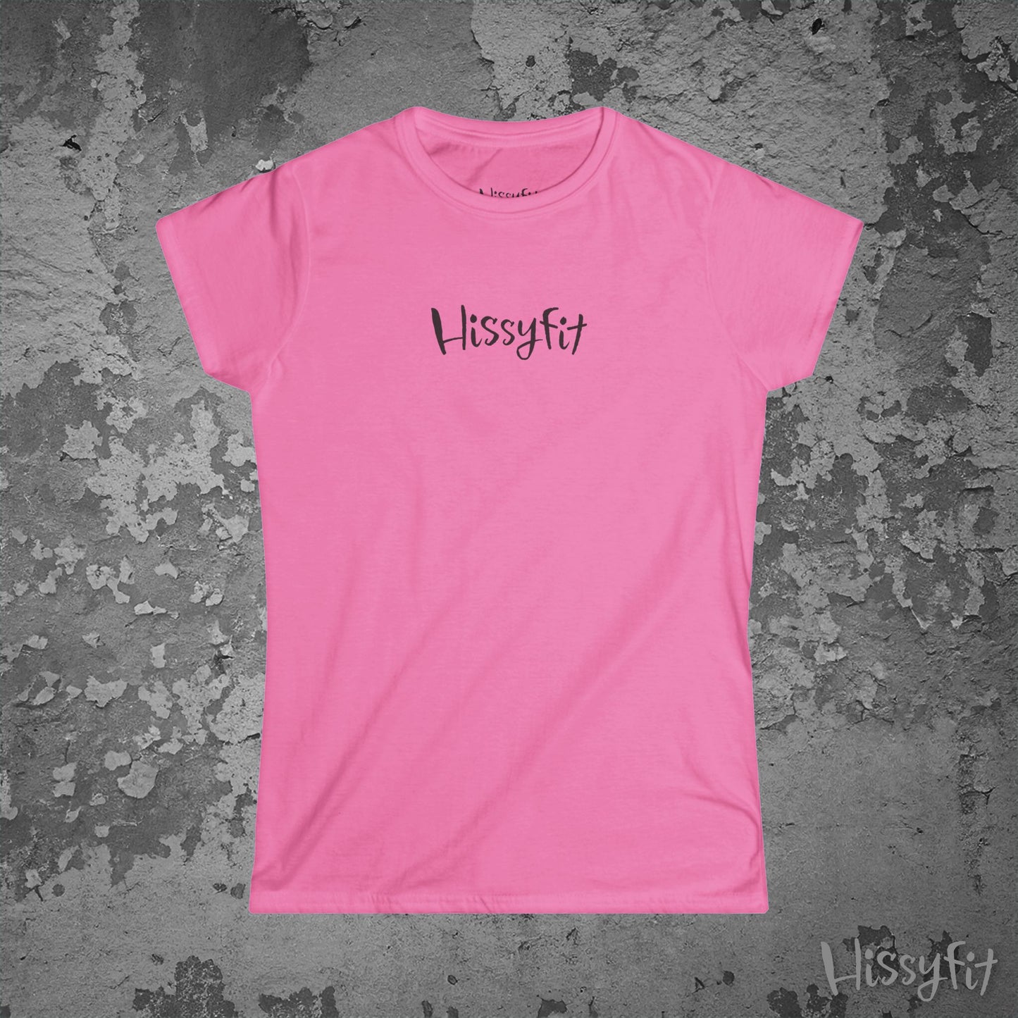 Pink t-shirt with 'Hissyfit' logo on a textured gray background