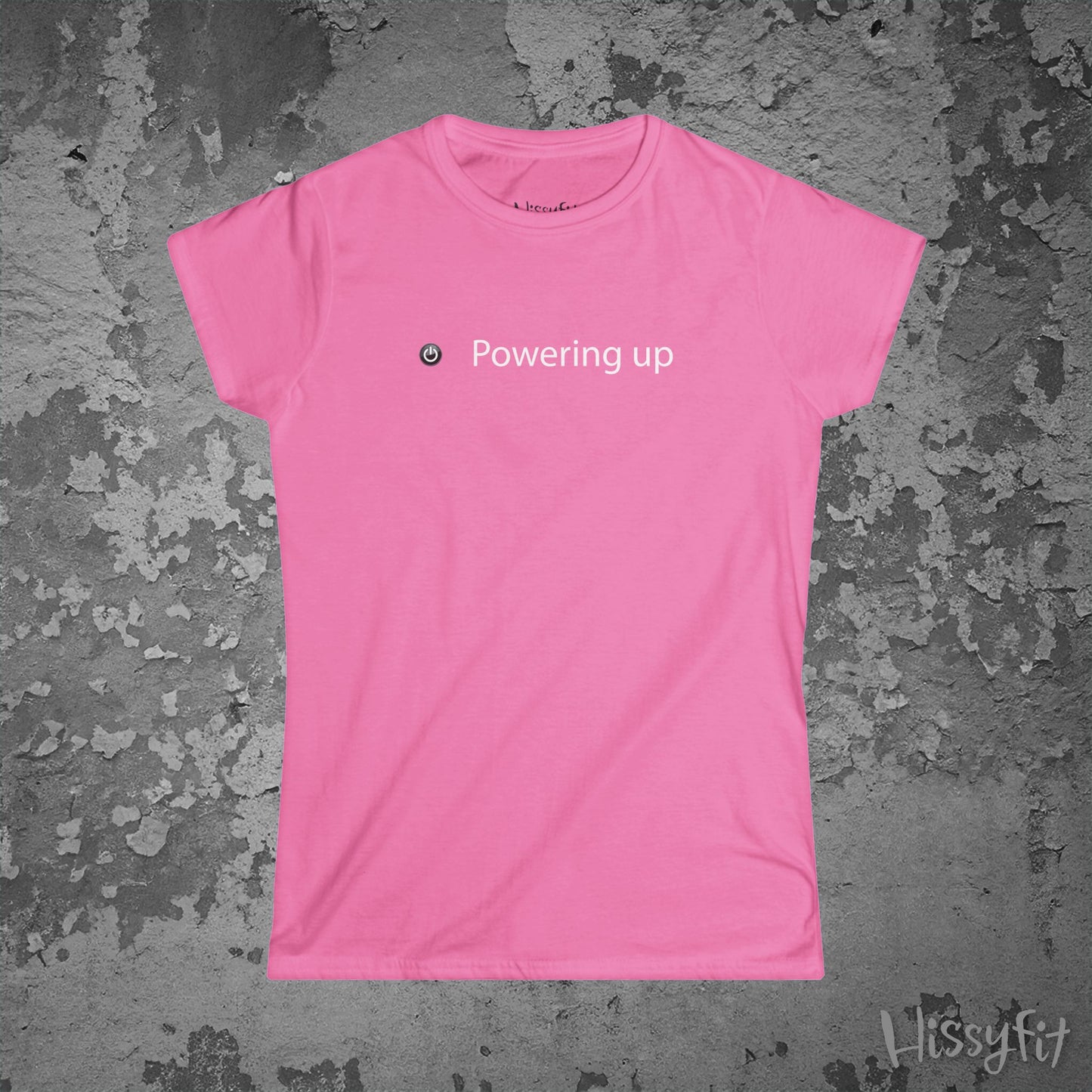 Pink t-shirt with 'Powering up' text on a textured gray background