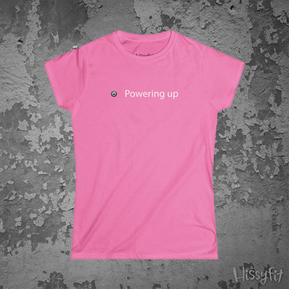 Pink t-shirt with 'Powering up' text on a textured gray background