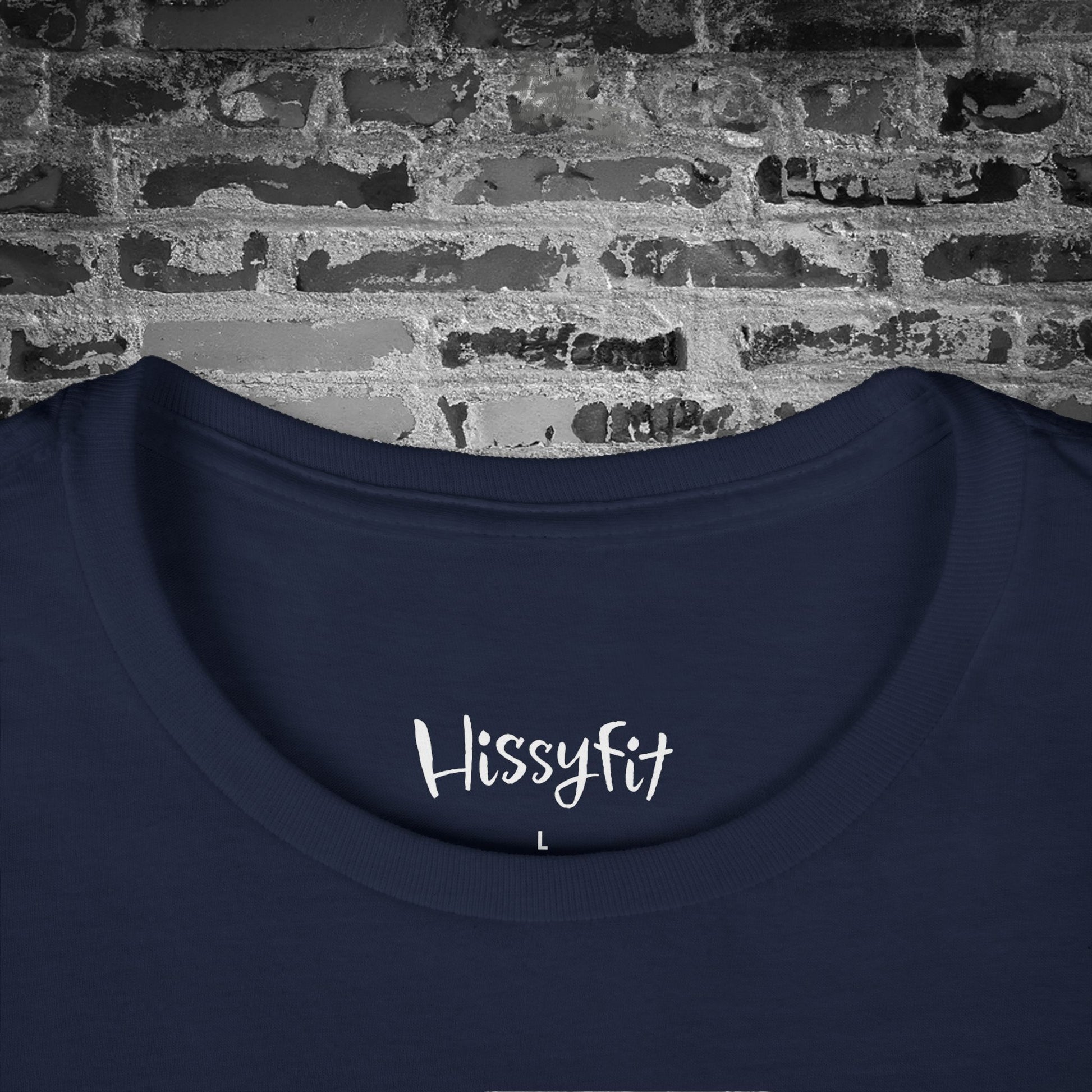 Navy blue shirt with 'Hissyfit' text on a brick wall background