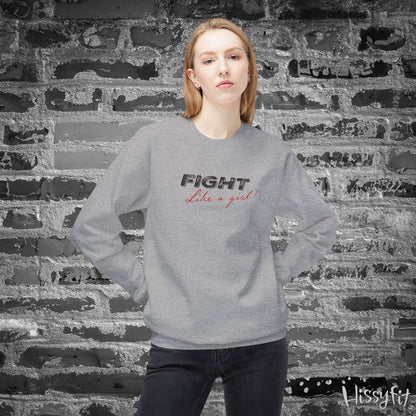 Person wearing a gray sweatshirt with 'Fight Like a Girl' text against a brick wall.