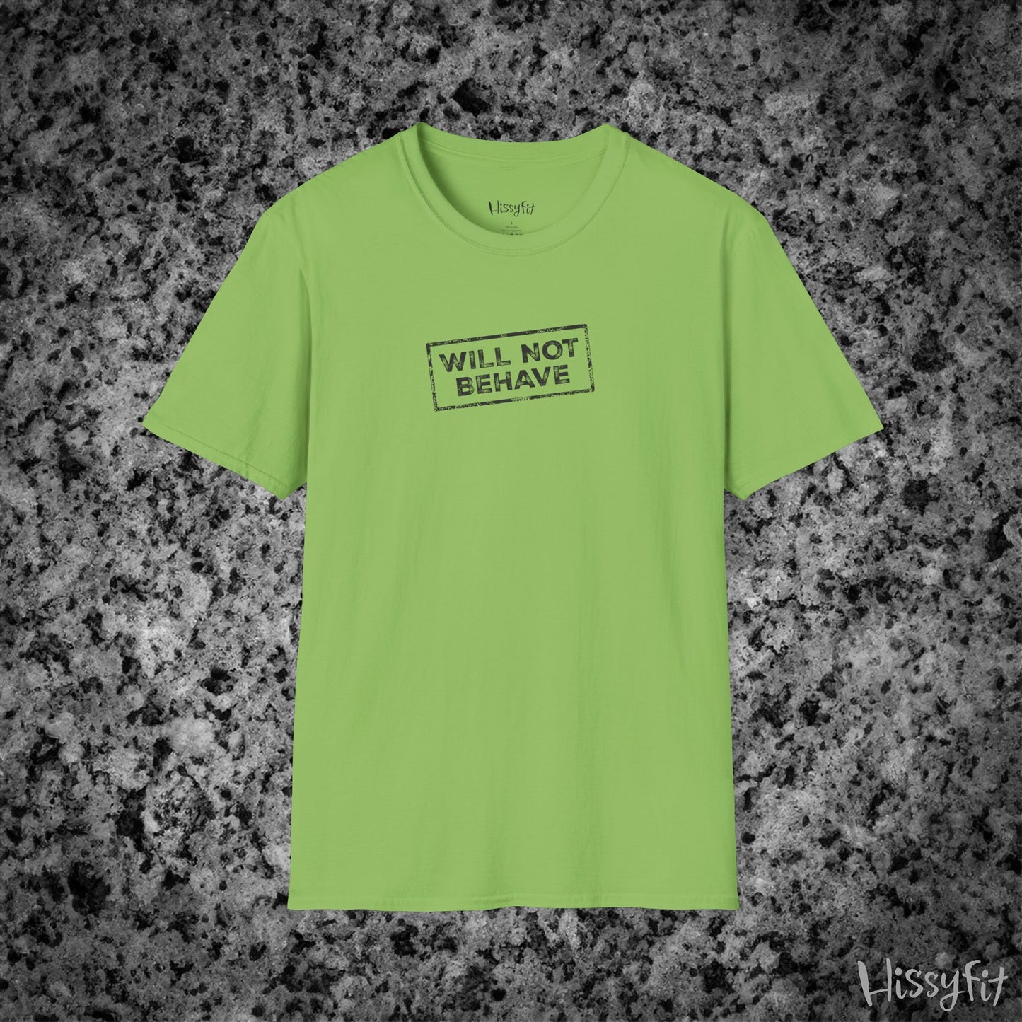 Green t-shirt with 'WILL NOT BEHAVE' text on a textured gray background