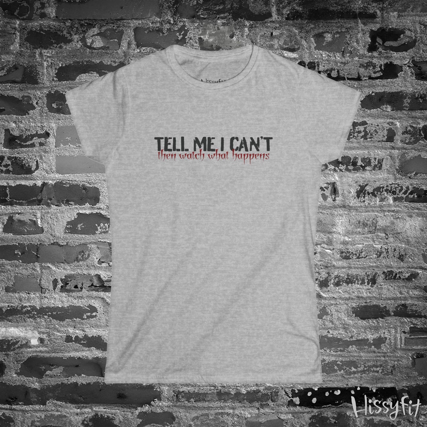 Gray t-shirt with motivational quote on a brick wall background