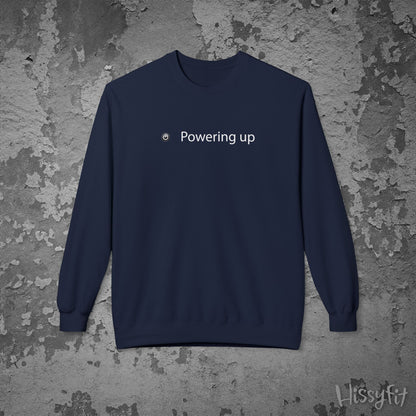 Navy blue sweatshirt with 'Powering up' text on a textured gray background