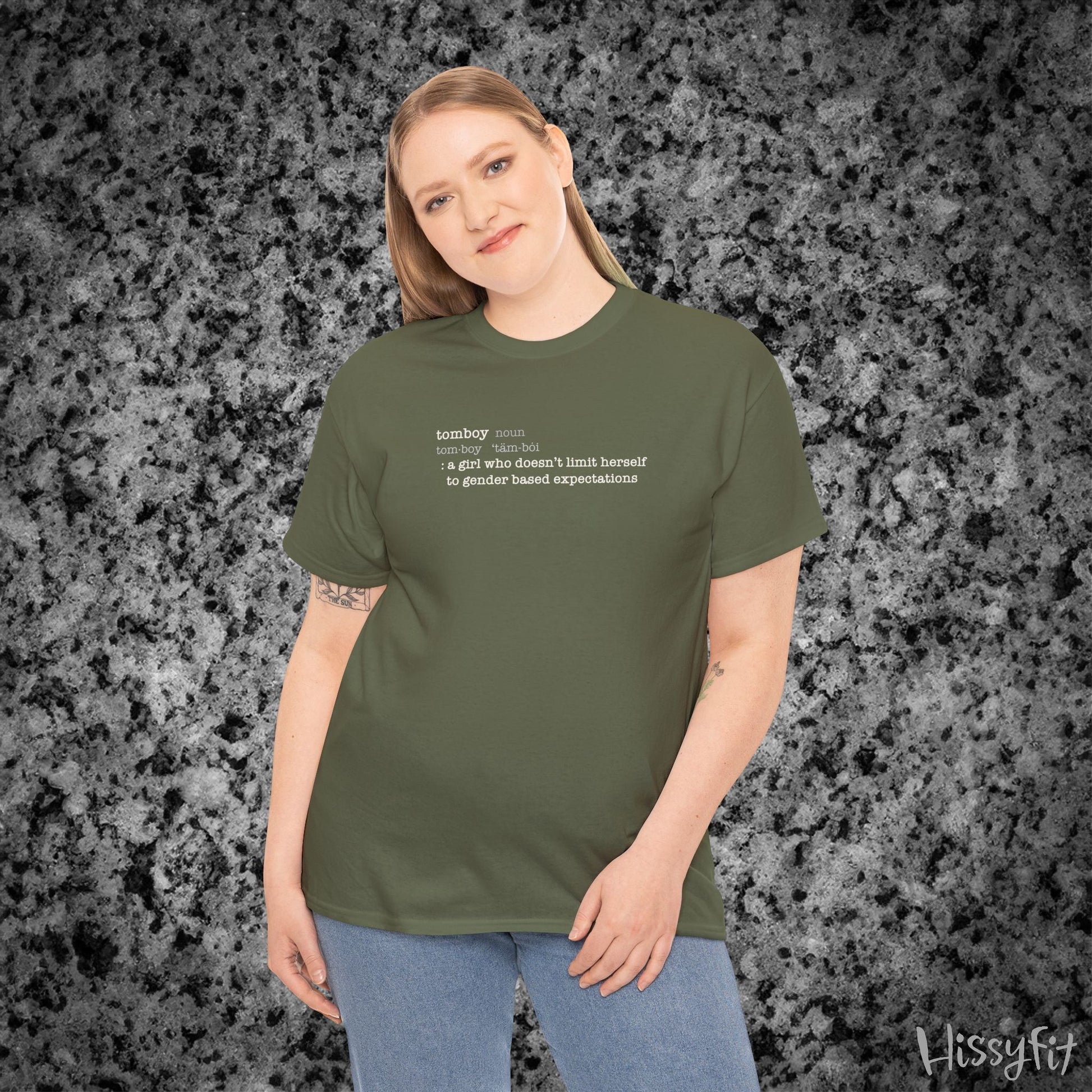 Person wearing a green t-shirt with text on a gray textured background