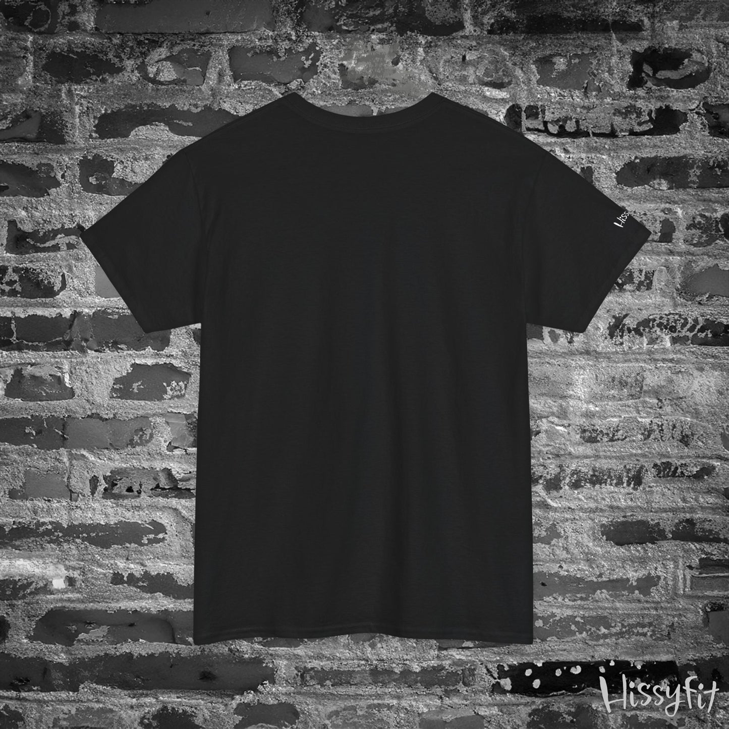 Black t-shirt against a textured brick wall