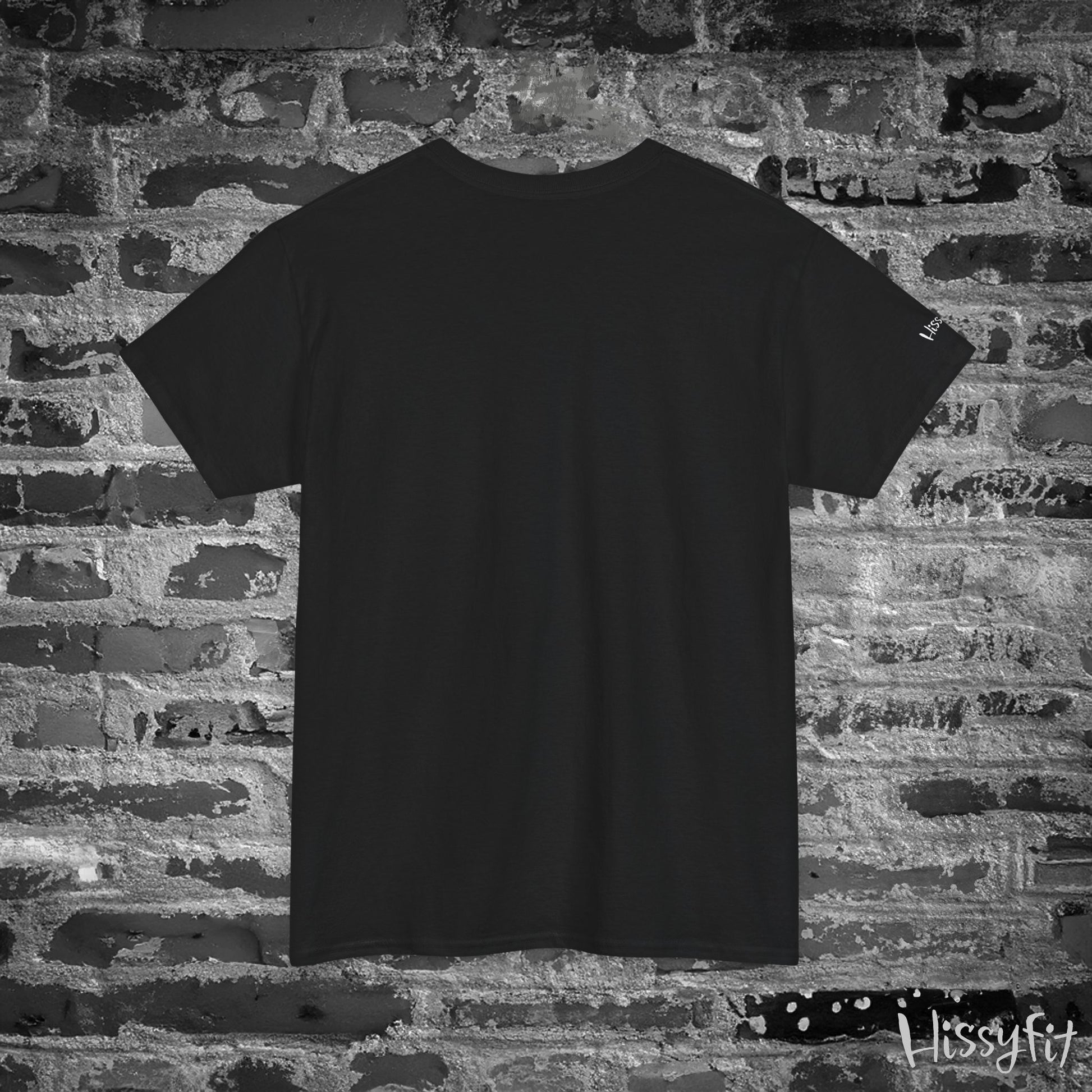 Black t-shirt against a textured brick wall