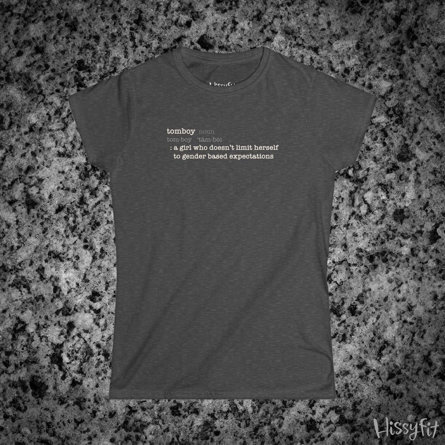 Gray t-shirt with text 'Tomboy:definition' on a gray granite surface, featuring the brand 'Hissyfit'.