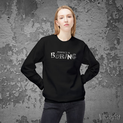 Person wearing a black sweatshirt with 'Perfect is Boring' text against a textured gray background