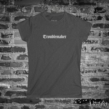 Gray t-shirt with 'Troublemaker' text on a brick wall background