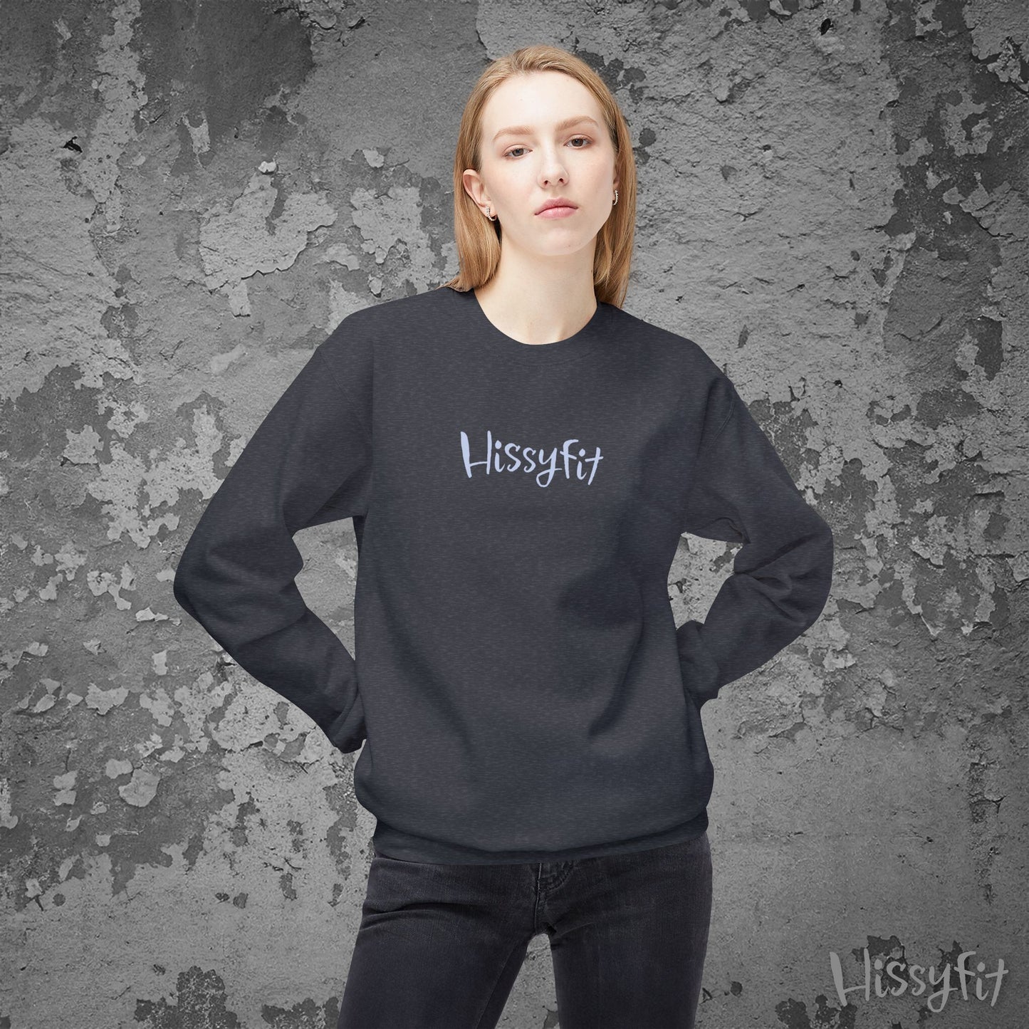 Person wearing a black 'Hissyfit' sweatshirt against a textured gray background