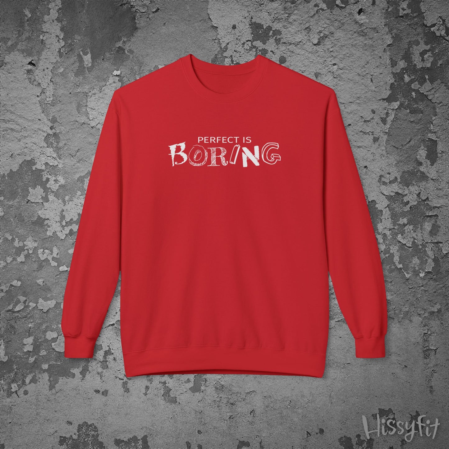 Red sweatshirt with 'PERFECT IS BORING' text on a textured gray background