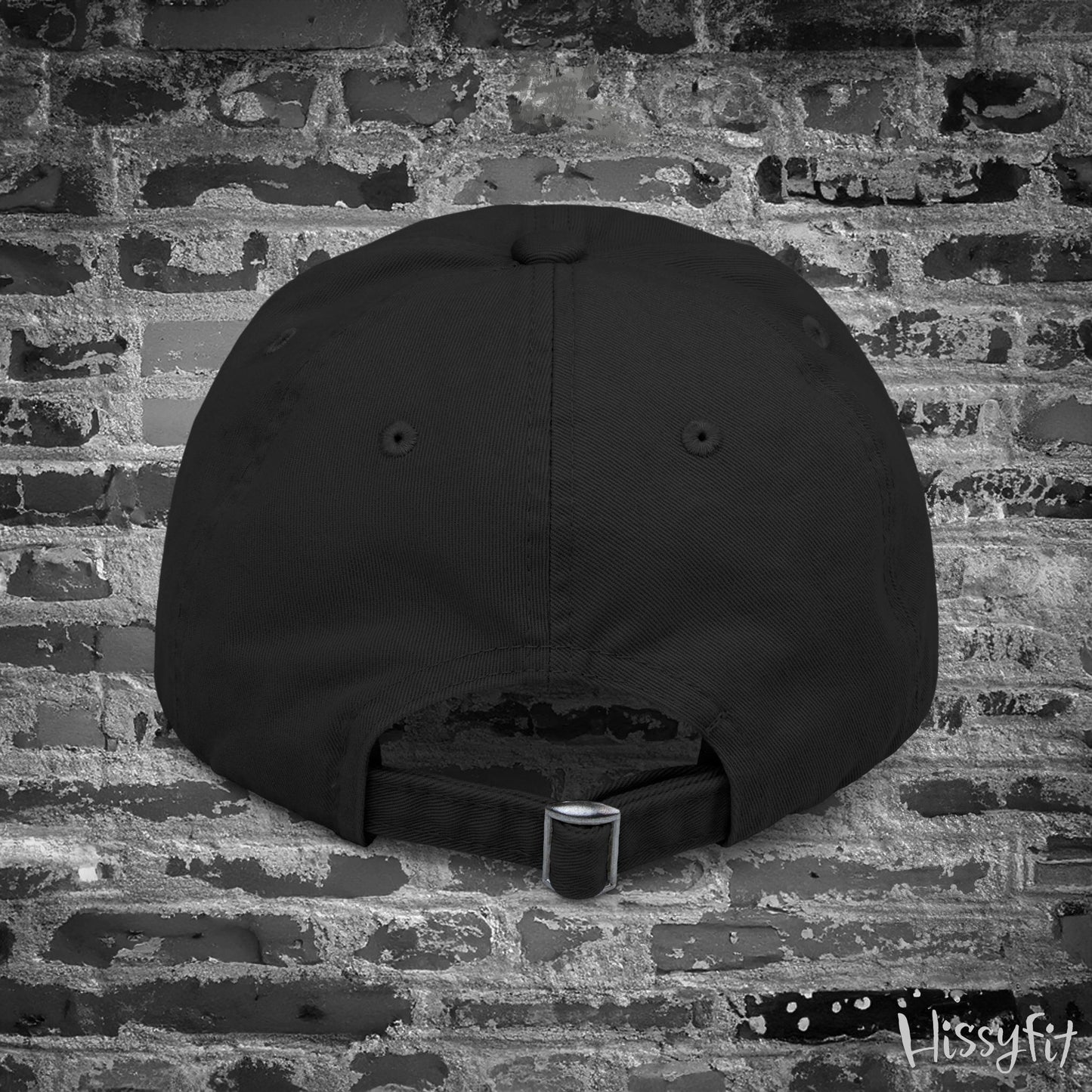 Black cap on a textured brick wall with 'Itsyfit' branding.