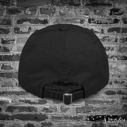 Black cap on a textured brick wall with 'Itsyfit' branding.
