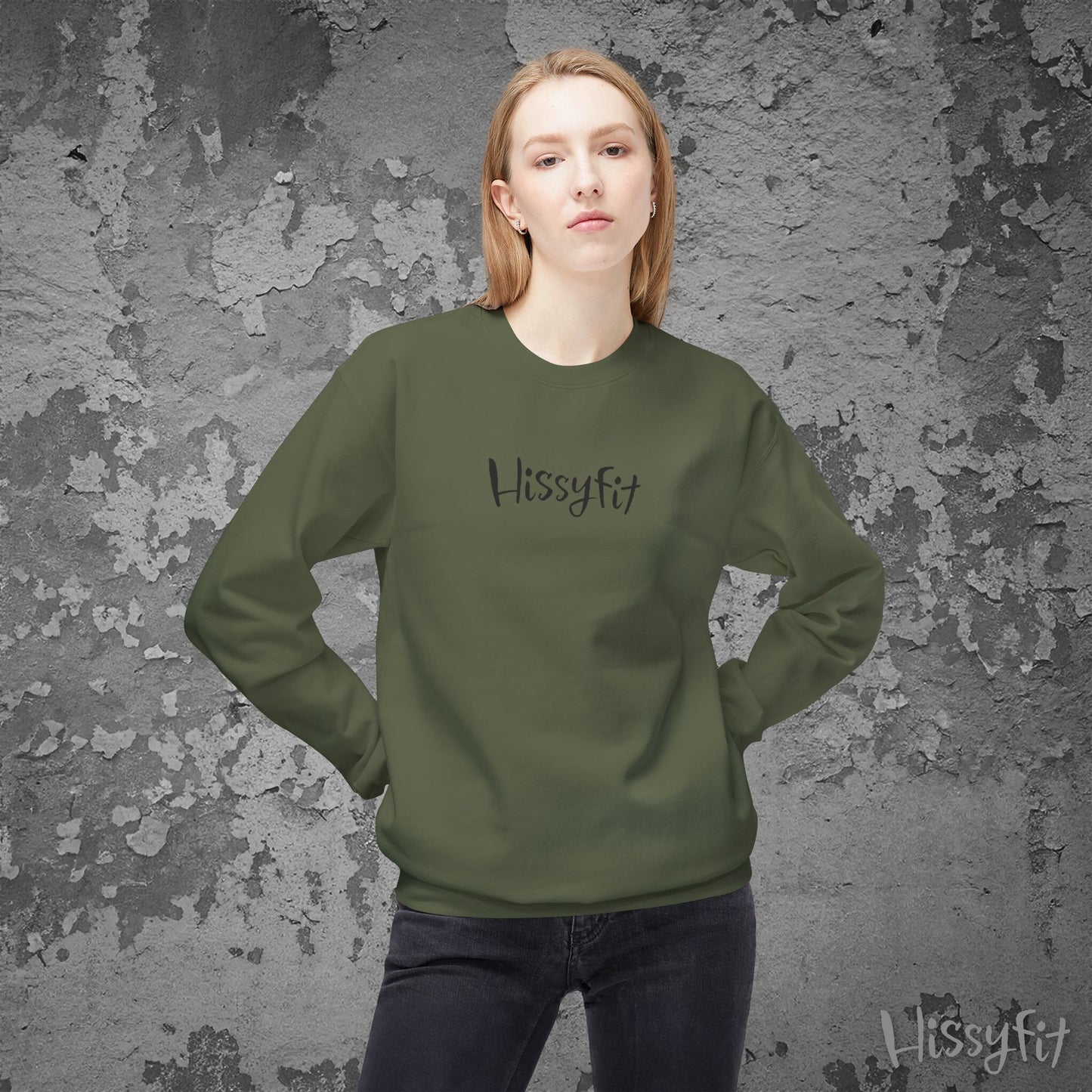 Person wearing a green 'Hissyfit' sweatshirt against a textured gray background