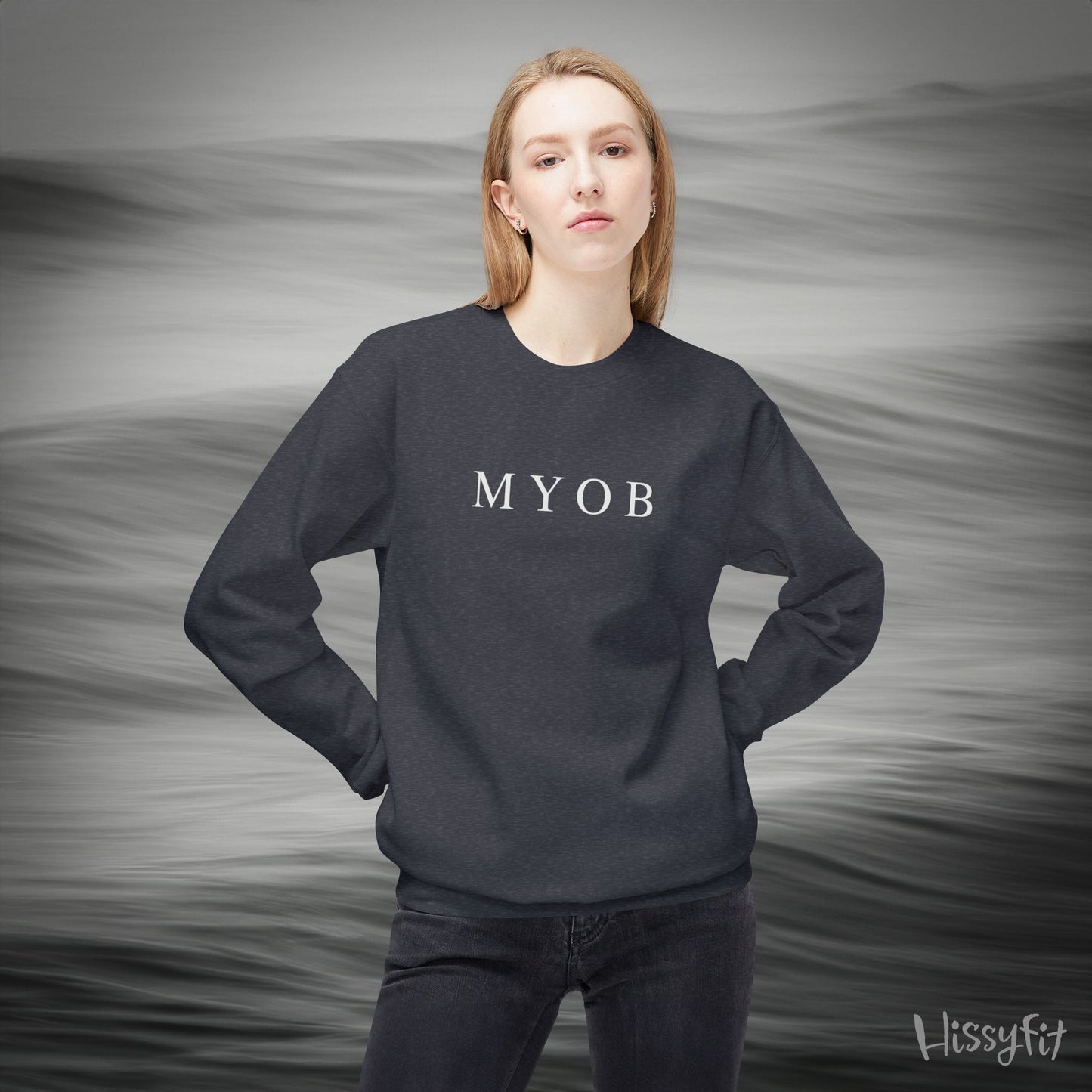 Person wearing a dark grey sweatshirt with 'MYOB' text against a gray background
