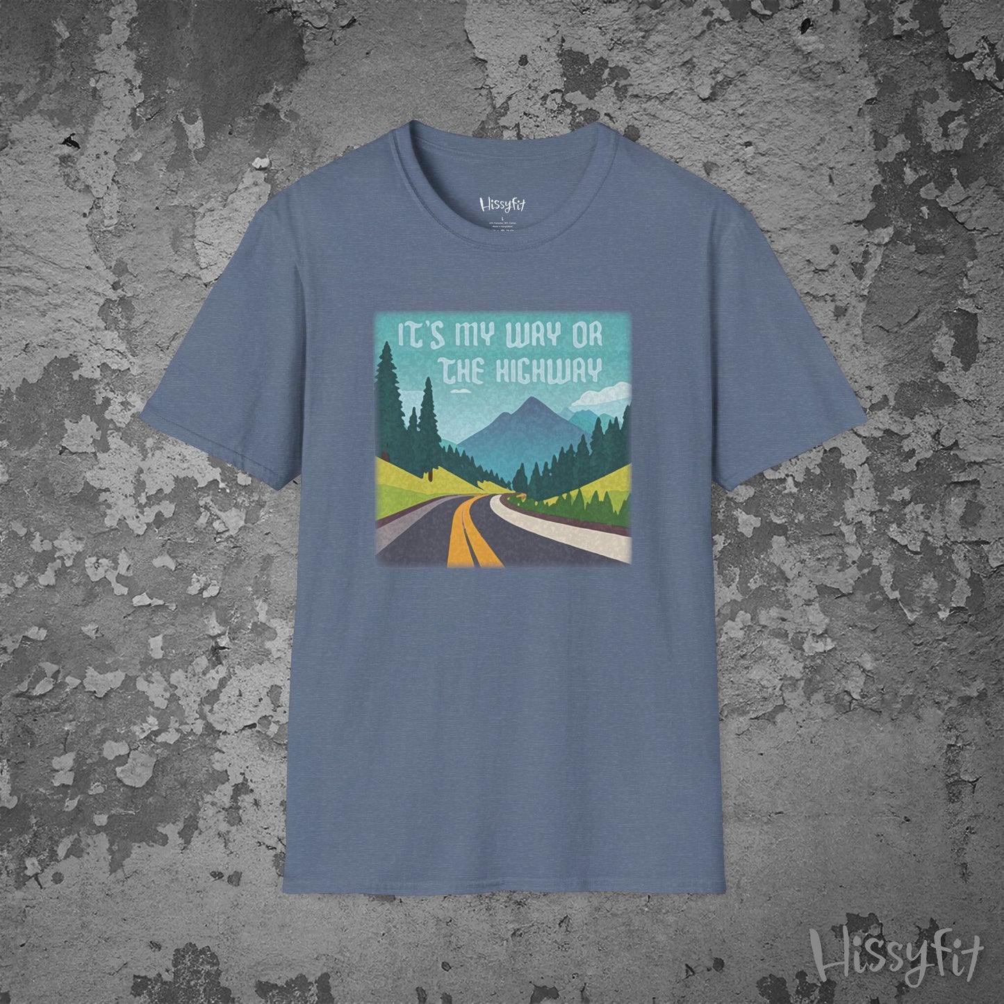 Blue t-shirt with a graphic design of a road and mountains and text 'It's my way or the highway' on a textured gray background