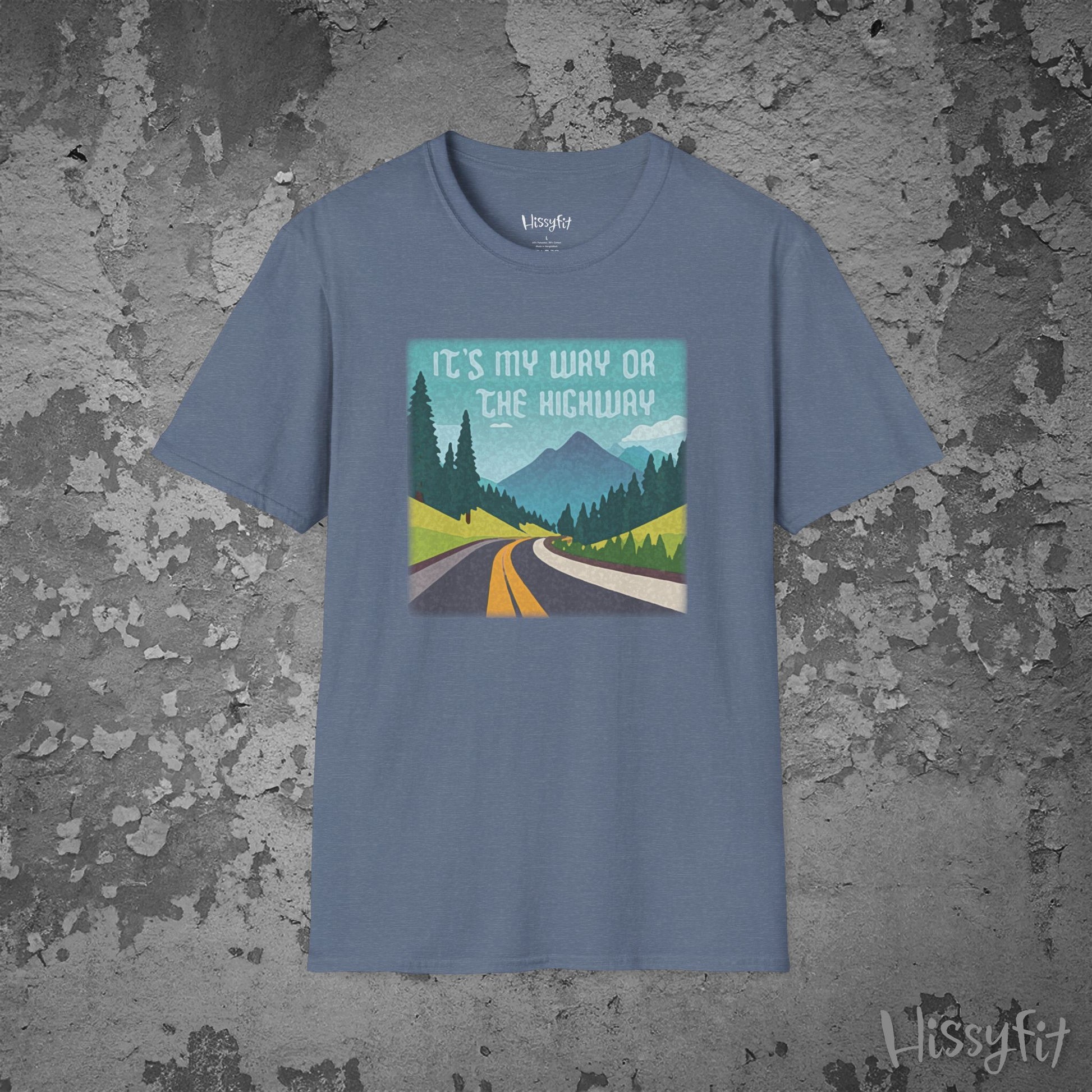 Blue t-shirt with a graphic design of a road and mountains and text 'It's my way or the highway' on a textured gray background
