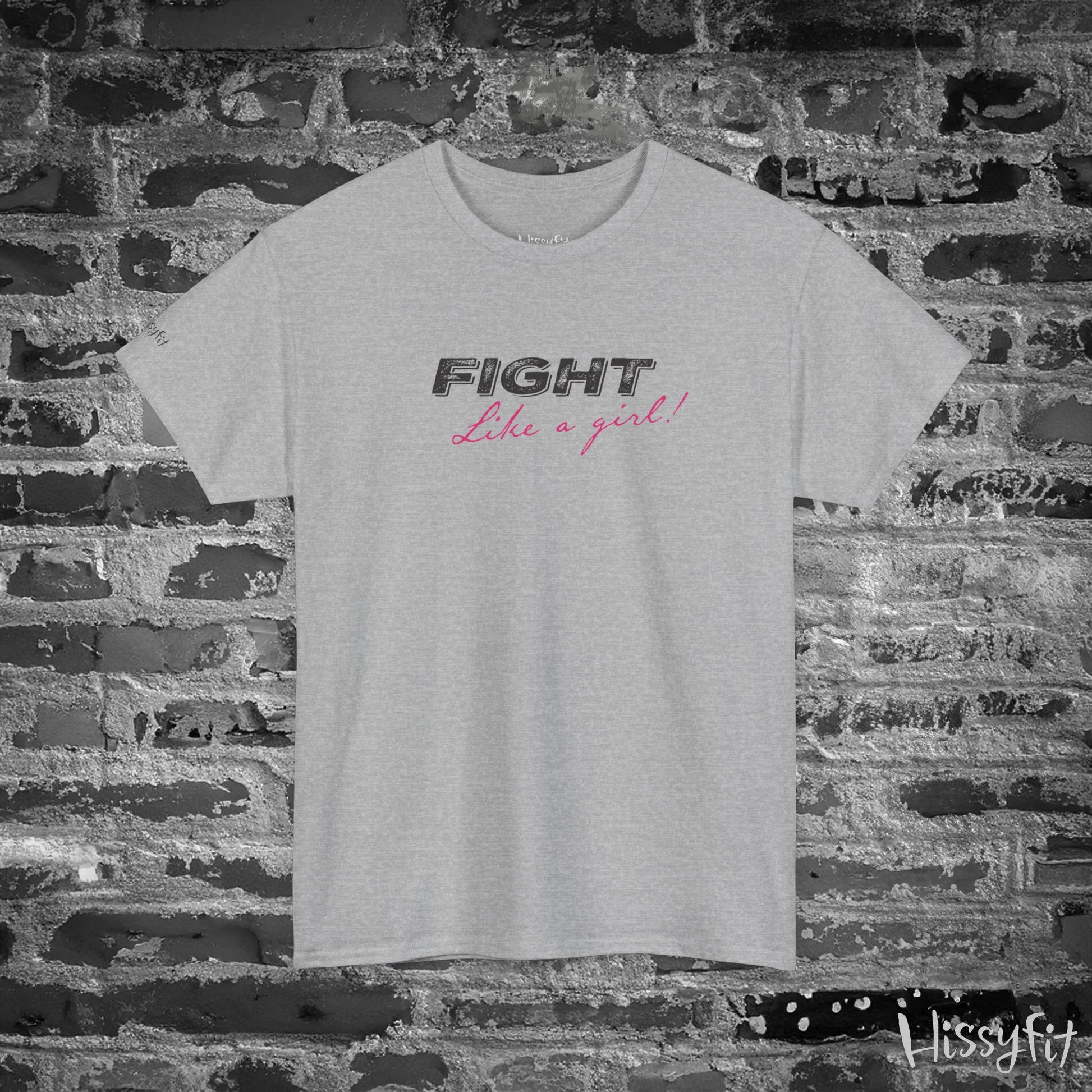 Gray t-shirt with 'Fight Like a Girl' text on a brick wall background